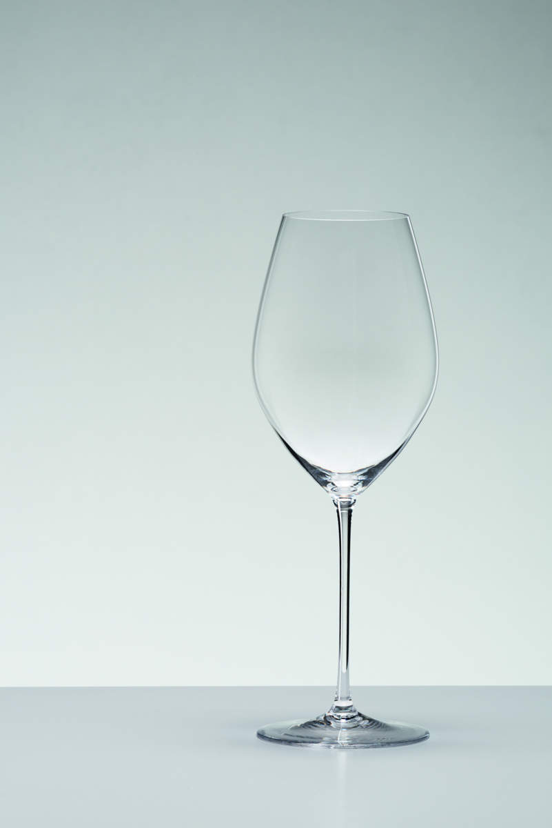 Leeres Riedel Glas Veritas Champagnerglas vor grauem Hintergrund