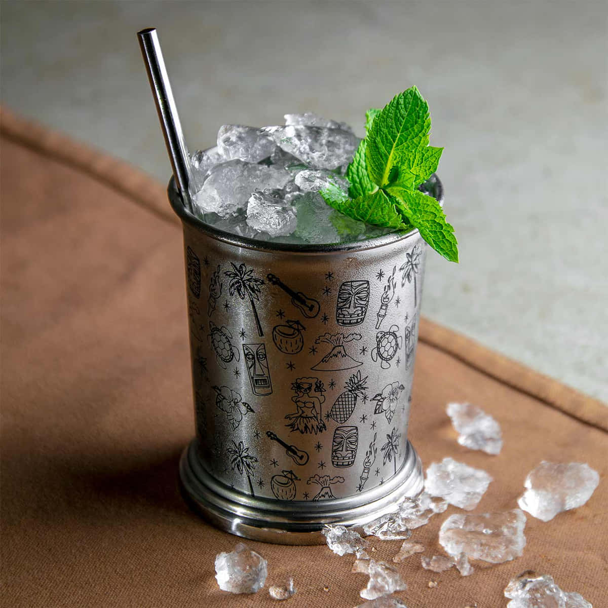 Julep Becher mit Tiki Motiven verziert ist mit Mint Julep Ccktail gefüllt
